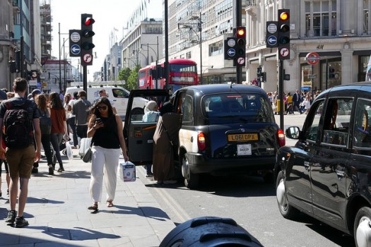 Shoppers, taxis and buses at Oxford Circus.